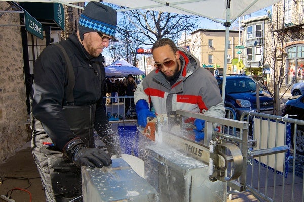 <p><p>Peter Slavin and Don Harrison use an Alaskan Mill saw to split a large block of ice. (Bas Slabbers/for NewsWorks)</p></p>
