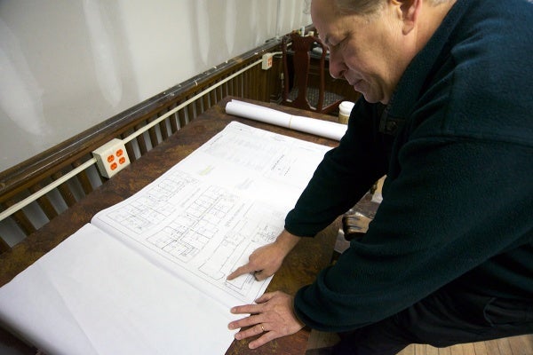 <p><p>Kroungold reviews plans for the apartments on the second and third floors of the building. (Bas Slabbers/for NewsWorks)</p></p>

