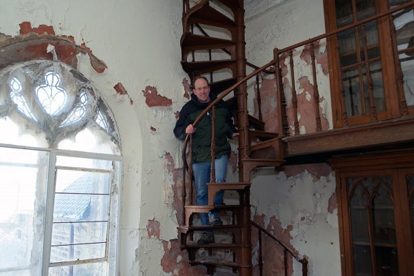 <p><p>Developer Ken Weinstein climbs a cast-iron staircase in the library. (Bas Slabbers/for NewsWorks)</p></p>
