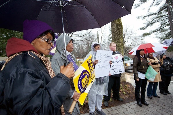 <p>Armed with umbrellas and protests signs a dozen security personal gathered on the corner of Henry Ave and School House Ln. (Bas Slabbers/for NewsWorks)</p>
