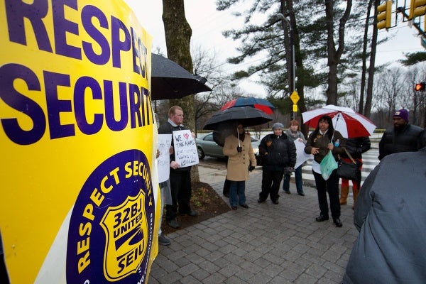 <p><p>Armed with umbrellas and protest signs, a dozen McGinn Security officers gathered on the corner of Henry Avenue and School House Lane to rally for better wages and working conditions. (Bas Slabbers/for NewsWorks)</p></p>
