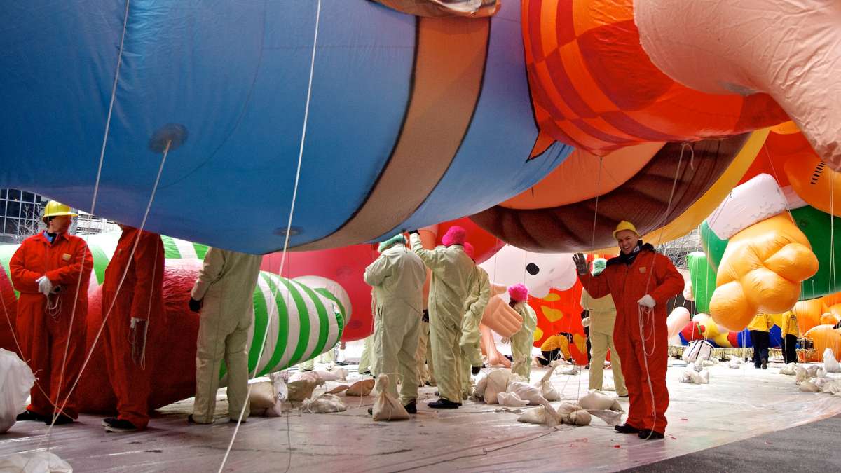 A scene before the start of the parade, as the balloons still sit on tarps on the street. (Bas Slabbers/for NewsWorks)