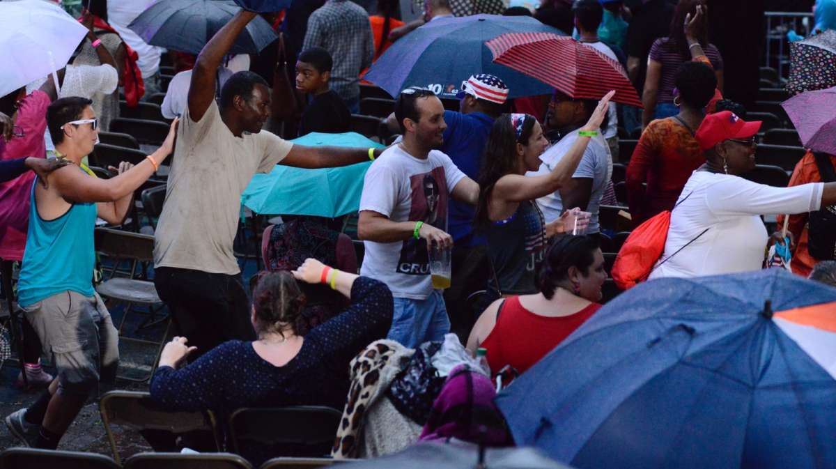 To keep spirits high, people in the crowd start a conga line.