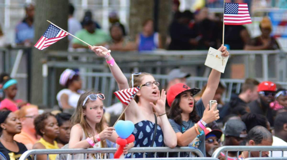 Flag waving fans cheer as Yazz the Greatest and Leslie Odom Jr. kick off the Wawa Welcome America 4th of July Concert on the Parkway.
