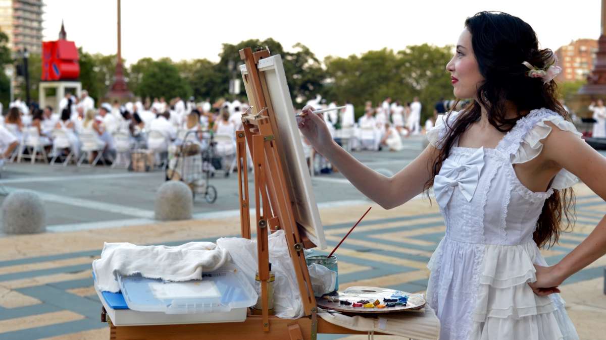 Jessica Libor sets up a painter's easel to capture the scene in oils.