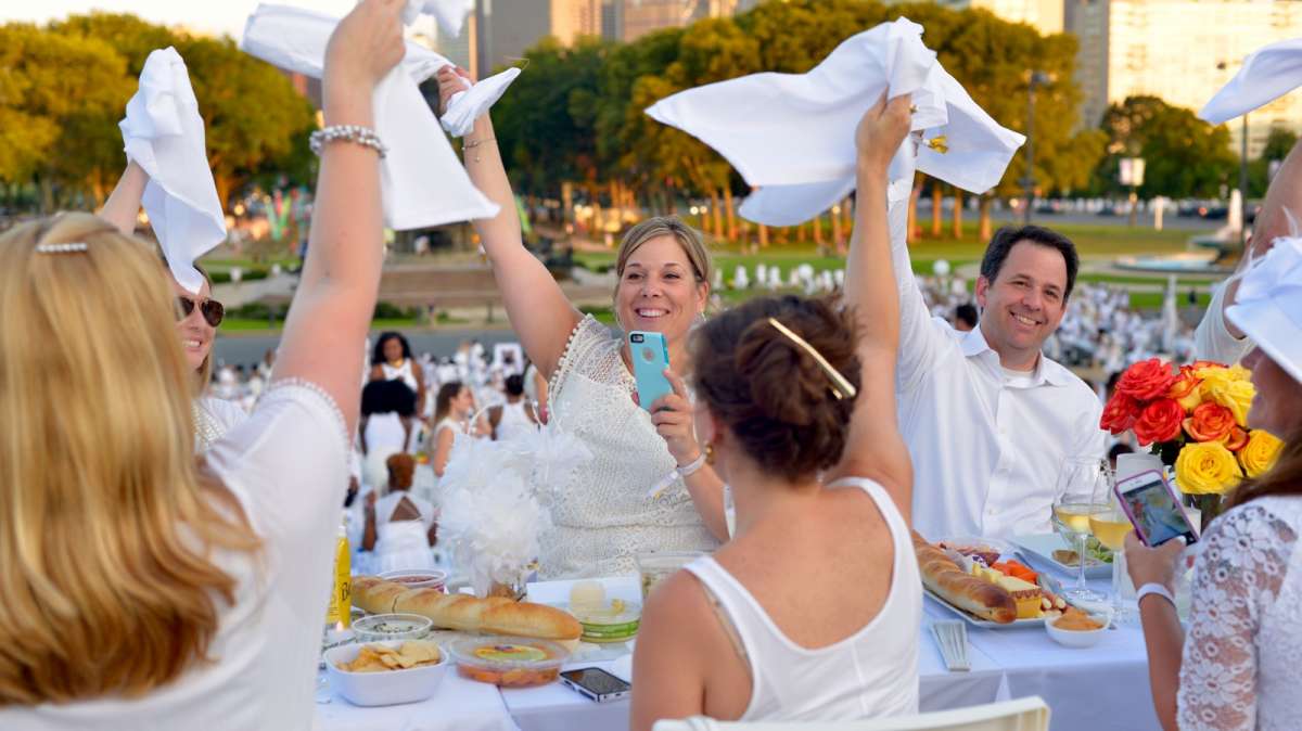 Guests wave their white napkins to signal the start of this year's Dîner en Blanc.