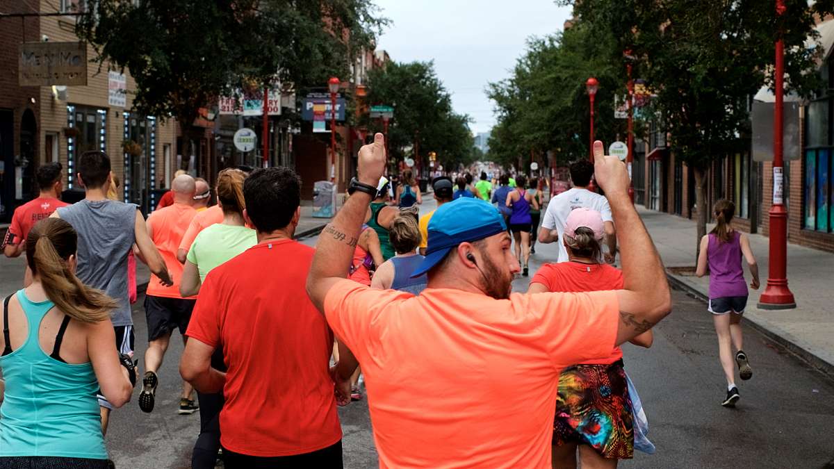 Joggers take off for a morning run over a car-free South Street during the Philly Free Streets Day.