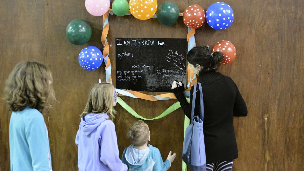 Refugees from all over the world enjoy their first Thanksgiving dinner at the Old Pine Community Center on Sunday. (Bastiaan Slabbers for NewsWorks)