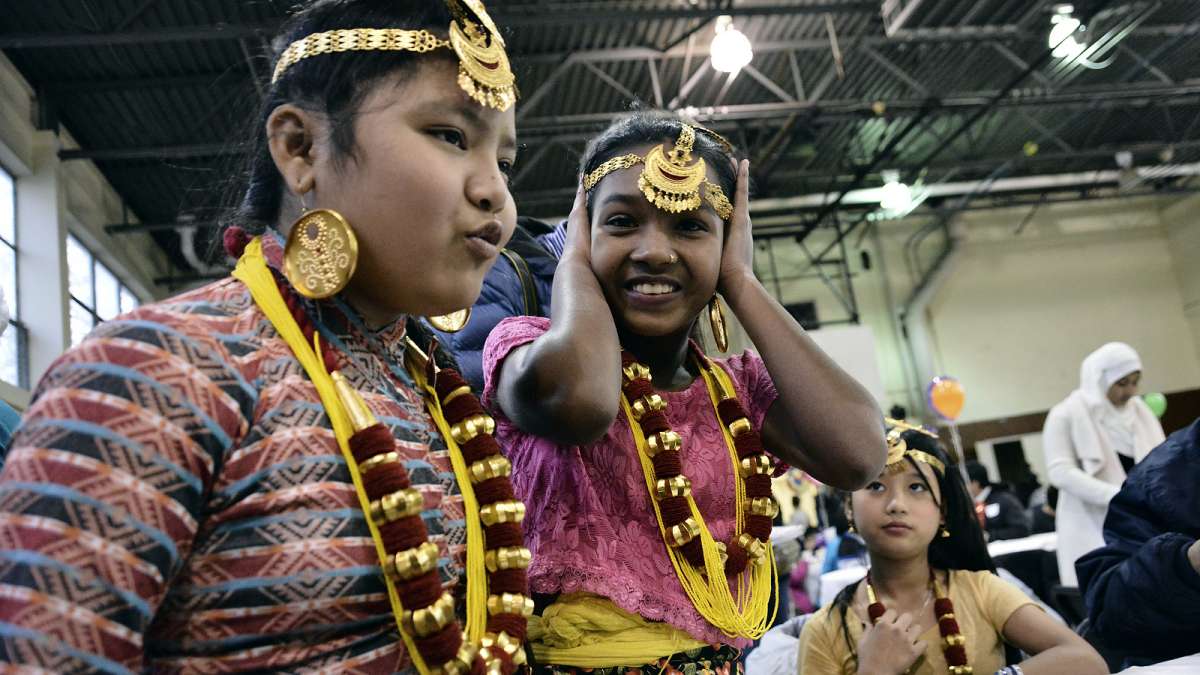 Members of the Rai family from Nepal wore colorful attire as they attended their first Thanksgiving dinner at Old Pine Community Center on Sunday. (Bastiaan Slabbers for NewsWorks)