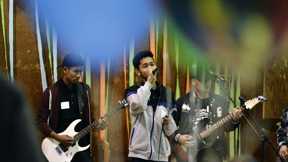 Neil Young's ''Rocking in the Free World'' is performed by a local high school band during the eighth annual Thanksgiving dinner for refugees at the Old Pine Community Center on Sunday. (Bastiaan Slabbers for NewsWorks)