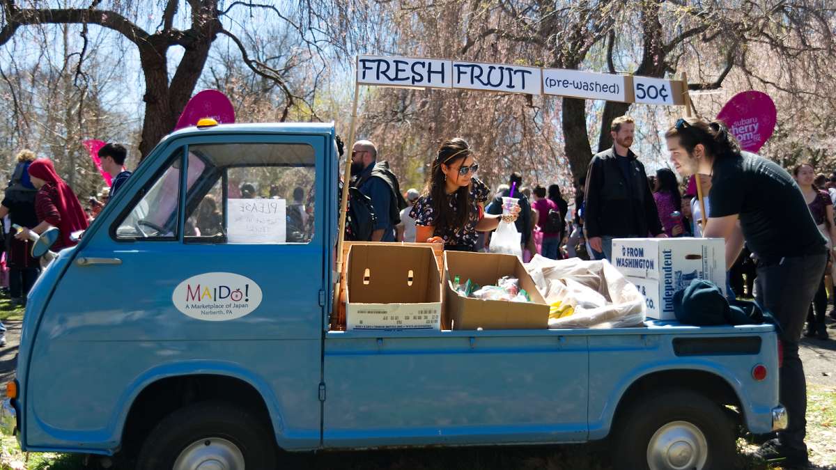 A nearly 50-year-old tiny Japanese pickup truck serves as a fresh fruit stand during the annual Cherry Blossom Festival in Fairmount Park on Sunday.