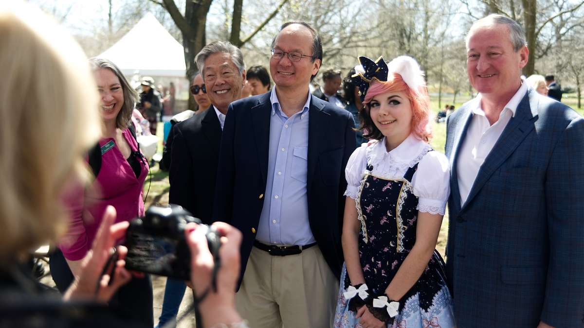 Philadelphia Mayor Jim Kenney and a delegation of Japanese dignitaries pose for photos during a tour of the festival grounds during the annual Cherry Blossom Festival in Fairmount Park on Sunday.