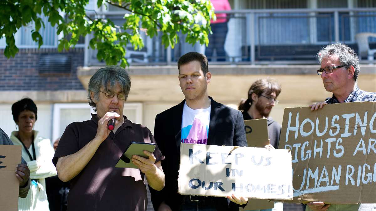 Craig Cheney (center) reads a list of demands from the residents, during an anti-eviction rally outside Penn Wynn House, on Wednesday.