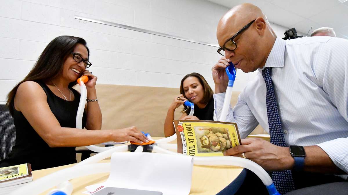 SPD Education facilities Planner Paula Sahm, Stearne Principal Mecca Jackson, and Superintendent Dr. William Hite demonstrate a whisper phone at Allen M. Stearne Elementary (Bastiaan Slabbers for WHYY)