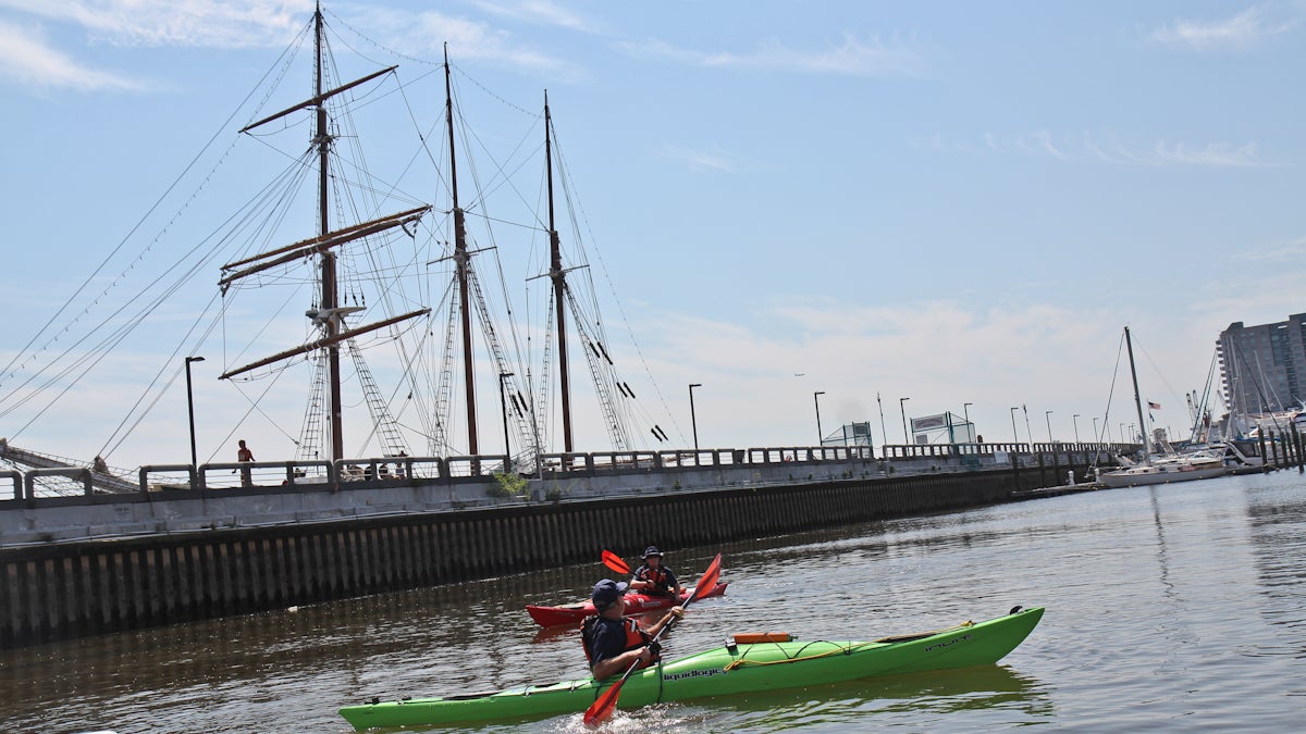  Joseph Smith and Laurie Huselton with the Coast Guard Auxiliary paddle on the Delaware River near Penn’s Landing. (Kimberly Paynter/WHYY) 