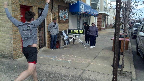 Matt Stanley finishes the relay. The finish line is right at the front door of Roberts Place, host of the after party. (Photo courtesy of Bobb Hawkey)