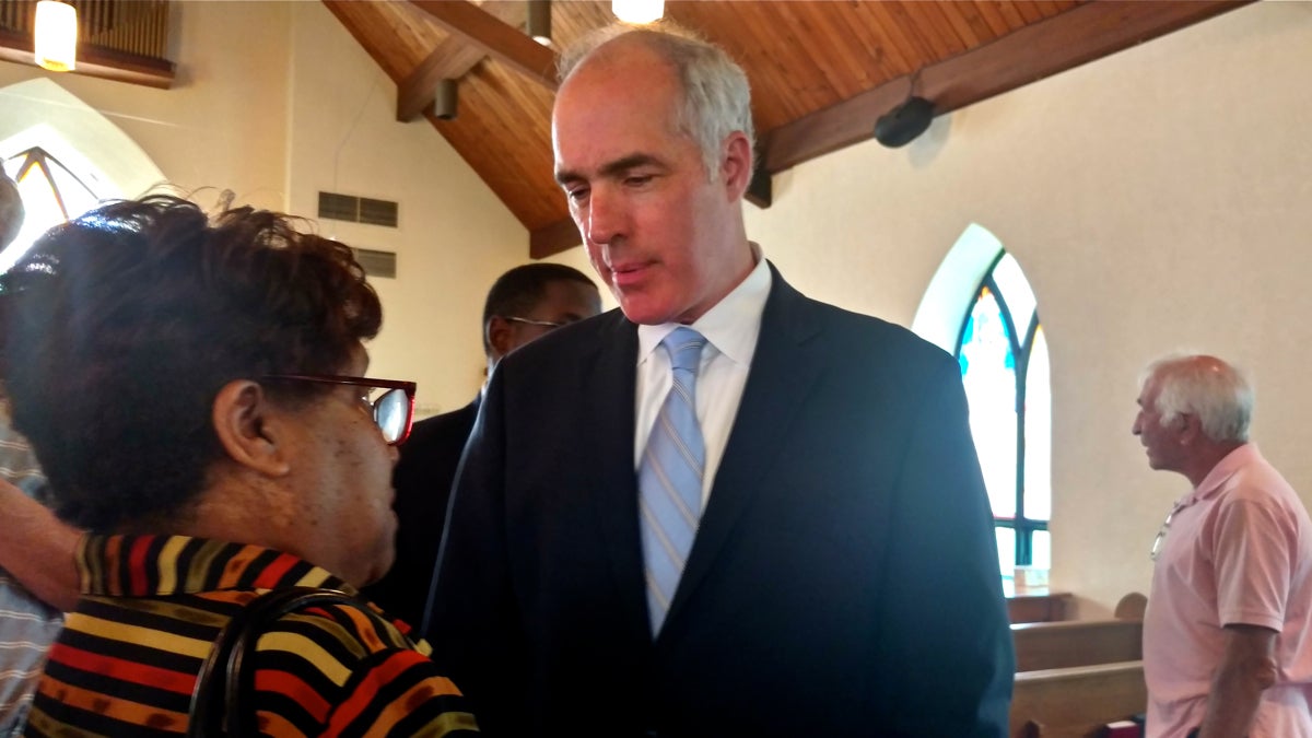  U.S. Sen. Bob Casey, D-Pennsylvania, speaks with a constituent at Bethel AME Church in Ardmore Monday. Casey is reintroducing a bill that would ban those convicted of misdemeanor hate crimes from buying firearms. (Katie Colaneri/WHYY) 