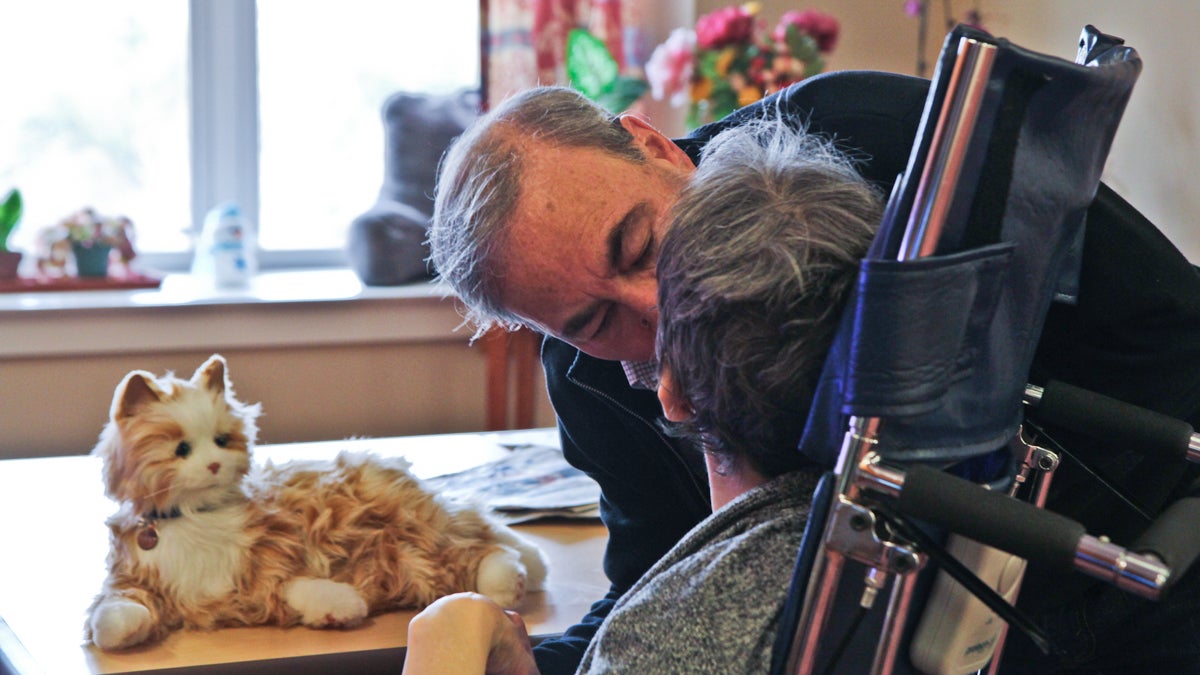  Mark Lipsitt bought a robotic cat for his partner Mary, a nursing home resident who has dementia, to bring her comfort. (Kim Paynter/WHYY) 