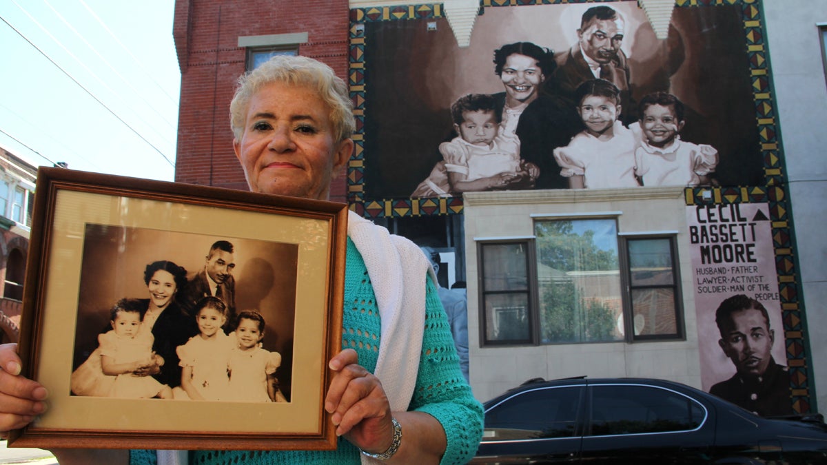 Cecily Banks, the oldest daughter of Cecil B. Moore, stands beside a mural honoring her father at the corner of West Jefferson and North Bouvier streets. (Emma Lee/WHYY) 