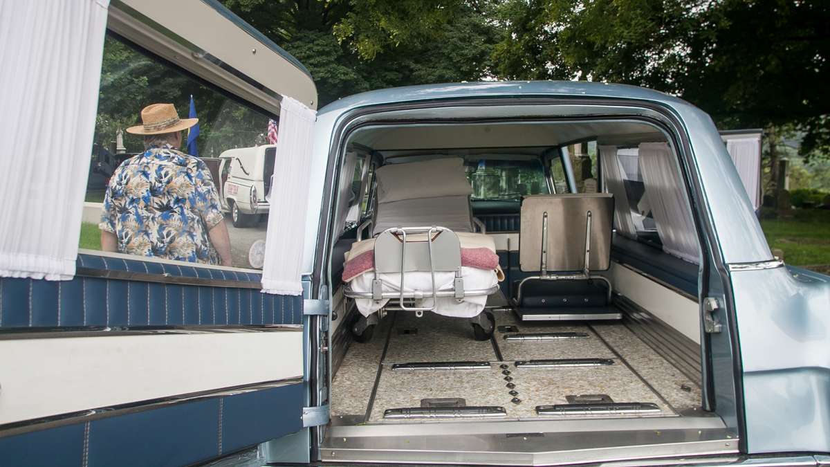 Visitors inspect he interior of a 1963 S & S Cadillac Park Row combination car that doubled as an ambulance and a hearse. (Brad Larrison for NewsWorks)