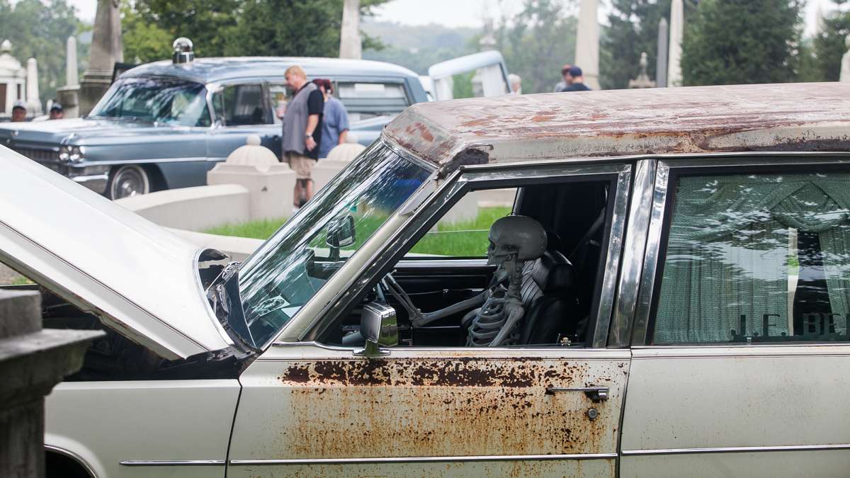A skeleton sits behind the wheel of a 1977 Cadillac Superior hearse. (Brad Larrison for NewsWorks)