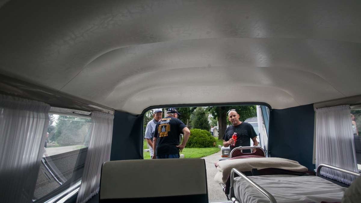 Visitors inspect he interior of a 1963 S & S Cadillac Park Row combination car that doubled as an ambulance and a hearse. (Brad Larrison for NewsWorks)