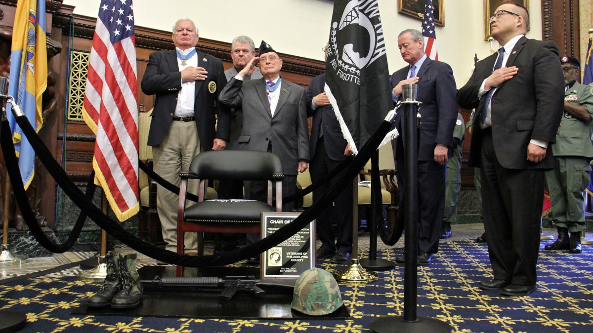  Medal of Honor recipients (front row from left) Mike Thornton and Hershel ''Woody'' Williams salute during the unveiling  ceremony for a Chair of Honor in the Mayor's Reception Room at City Hall. (Emma Lee/WHYY) 