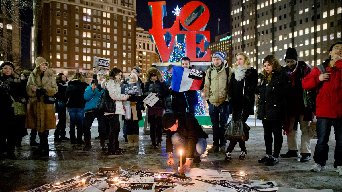  People are shown gathering on Jan. 9, 2015, at JFK Plaza  in Philadelphia, to pay tribute to victims of the terrorist attack against the French satirical weekly Charlie Hebdo. (AP Photo/Matt Rourke) 