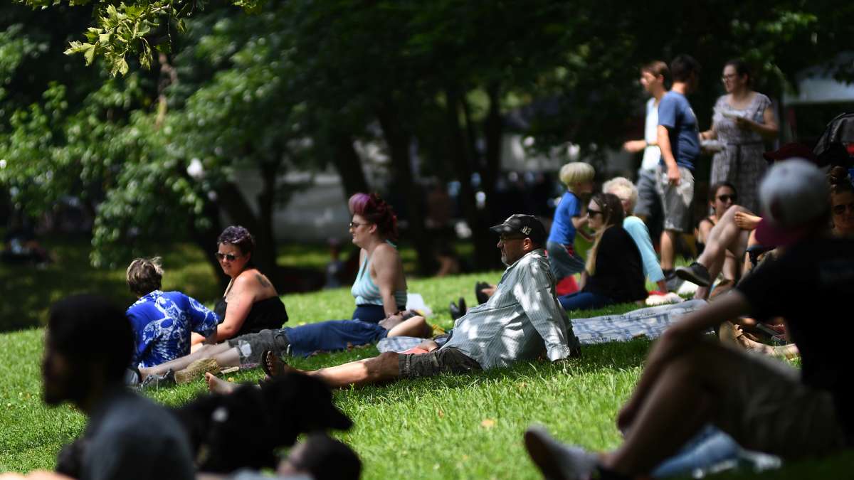 The trees lining the wide grass field provide plenty of shade for fans of one of the acts taking center stage at the annual Clark Park Festival, in West Philadelphia