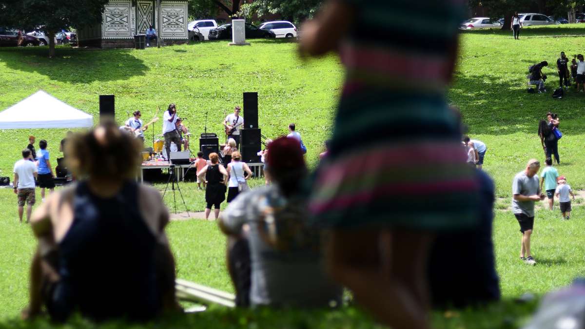 The trees lining the wide grass bowl provide plenty of shade for fans of one of the acts taking center stage at the annual Clark Park Festival