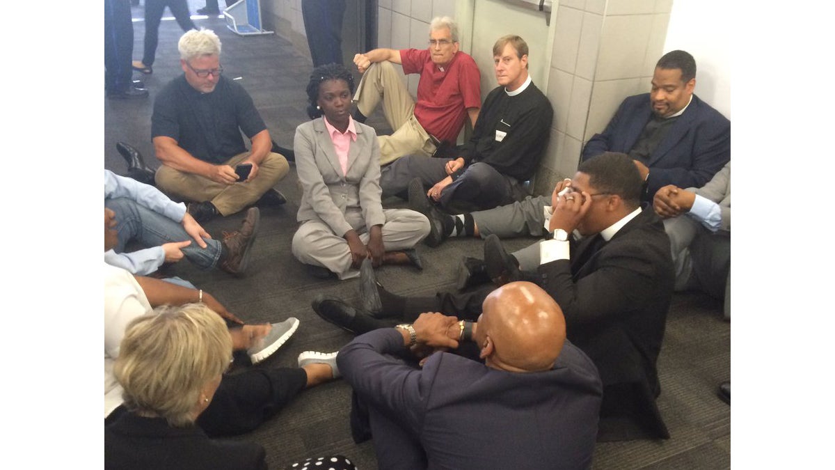  Members of the clergy stage a sit-in at Philadelphia International Airport (photo via <a href=