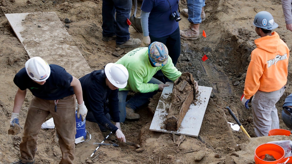  Workers excavate a coffin from a construction site in the Old City neighborhood Thursday in Philadelphia. Crews working on an apartment building in Philadelphia's historic district got a shock last month when their backhoes started hitting coffins and unearthing fully intact human remains. The site was supposed to be a former burial ground from 1707, and all remains were supposedly exhumed in the 1800s and moved to a different cemetery. (Matt Slocum/AP Photo) 