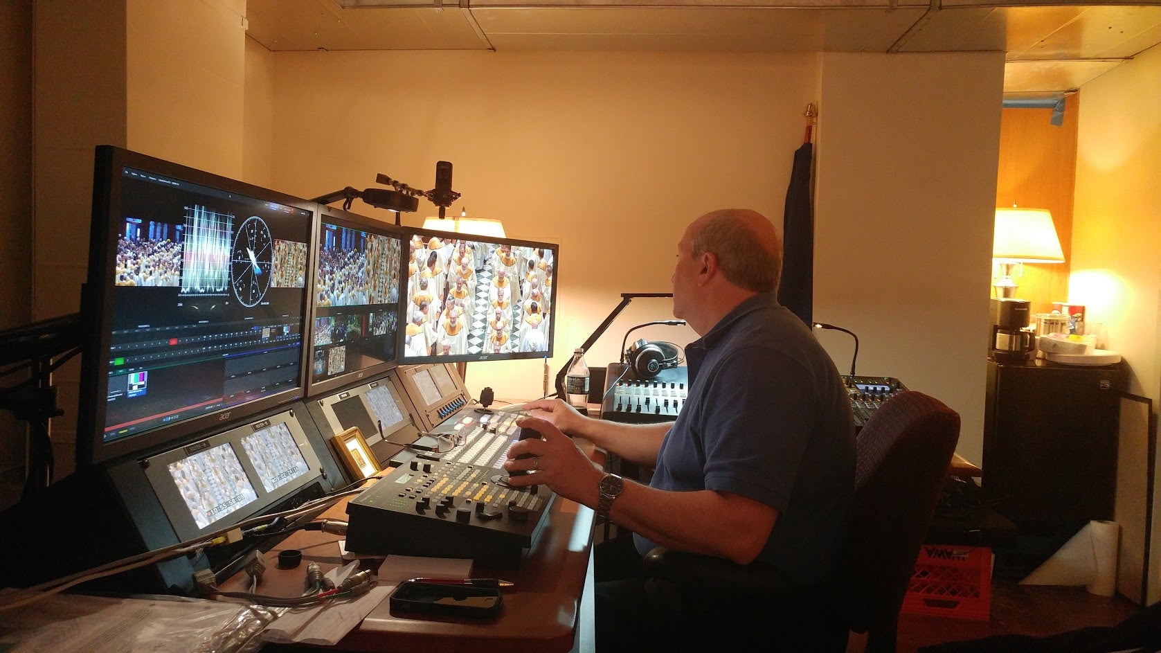  Dan Kerns operates robotic cameras at the 'cathedral control room,' located behind the altar. (Tom MacDonald/WHYY) 