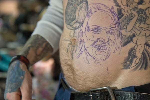 Tattoo artist Tom Hazelton is preparing to get a tattoo of his fiance, Candy.  (Kimberly Paynter/For NewsWorks)