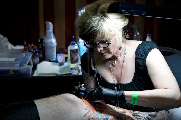 Cynthia Rudzis from Washingon D.C. has been tattooing for ten years.  (Kimberly Paynter/WHYY)