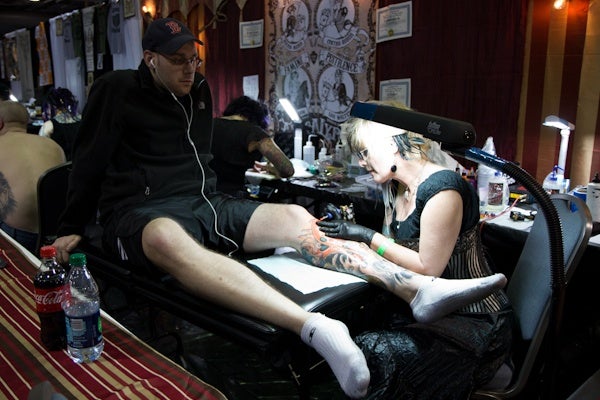 Dan Kowalczyk from Edison, N.J., has known D.C. tattoo artist Cynthia Rudzis for almost as long as she's been tattooing. (Kimberly Paynter/WHYY)