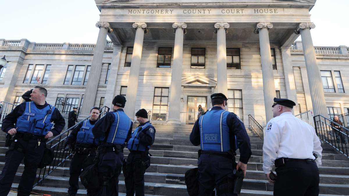 Police await the arrival of Bill Cosby outside the Montgomer County Courthouse in Norristown Tuesday morning.