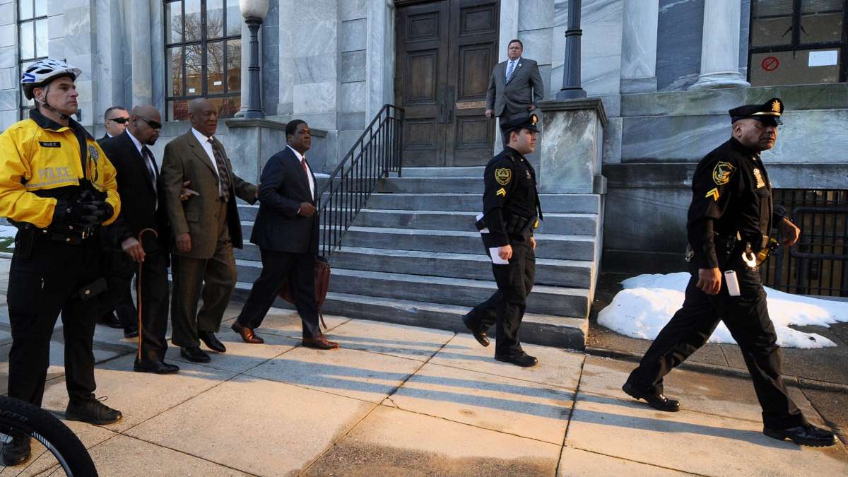 Police clear the way for Bill Cosby as he walks to the Montgomery County Courthouse for the first day of hearings in his sexual assault trial.