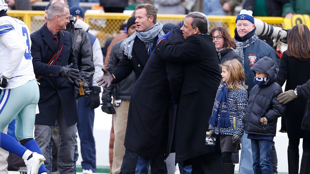  New Jersey Gov. Chris Christie, center right, embraces a person on the sidelines before an NFL divisional playoff football game between the Green Bay Packers and Dallas Cowboys Sunday in Green Bay, Wis. (AP Photo/Mike Roemer) 