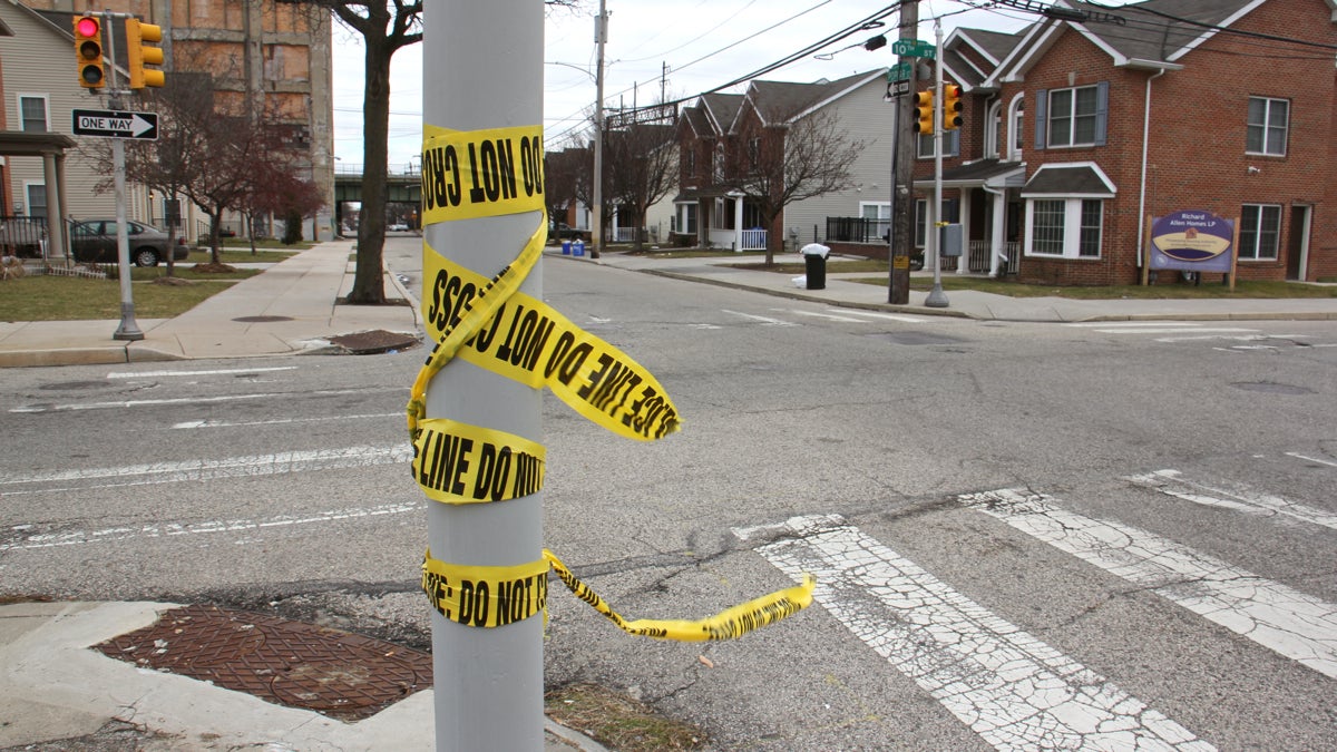 Crime scene tape remains at the intersection of 10th and Poplar streets. (Emma Lee/WHYY)