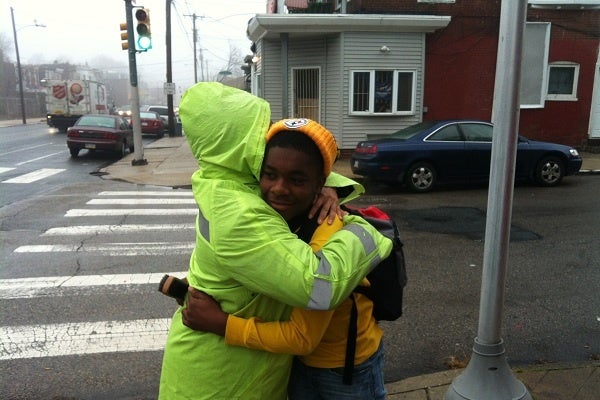 <p><p>Taylor hugs a student outside the East Germantown school. (Kiera Smalls/for NewsWorks)</p></p>
