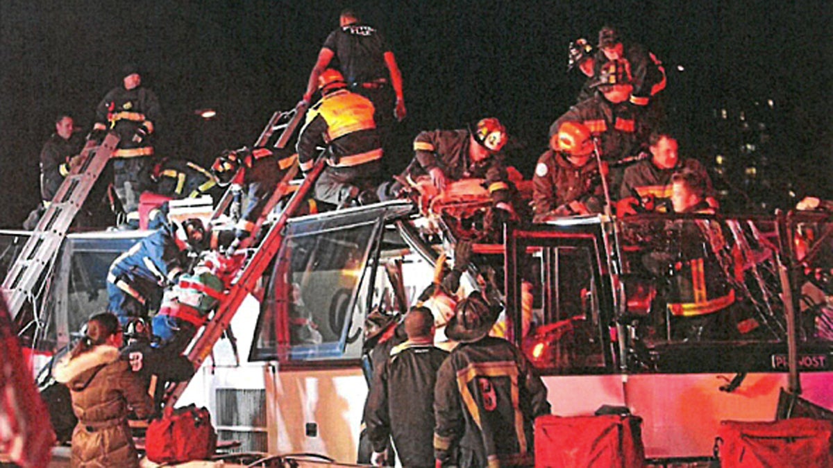 First responders provide aid to victims after a tour bus struck an overpass (Image via Civil Action court filing/Trial Court of Massachusetts, County of Suffolk) 