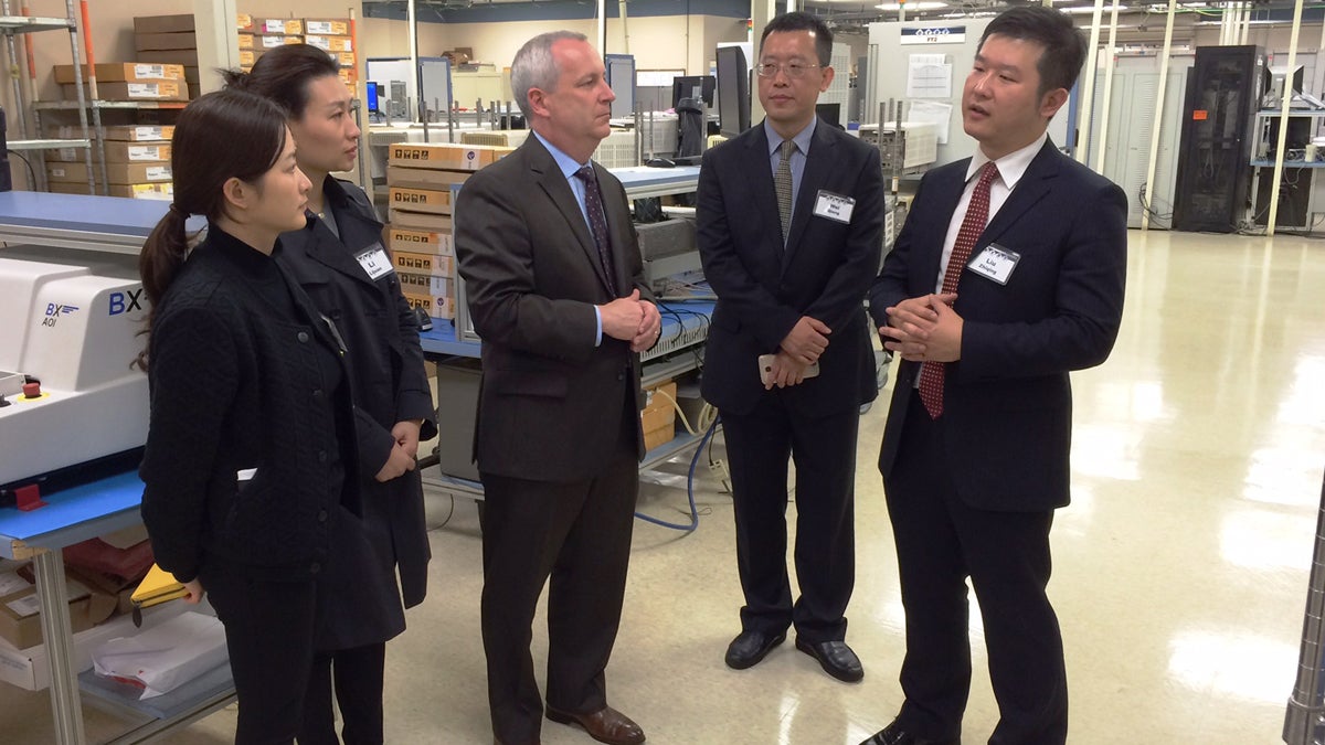  David Burt (center), a CTDI  vice president, explains the company's operations to a delegation from China at the company's West Goshen facility last year. CTDI currently does business at 13 locations throughout China. (Chester County commissioners office) 