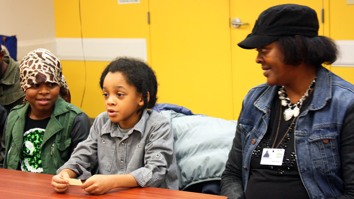  Donna Washington and her kids, Christenea and Christopher Archer, take part in a program at Child and Family Connections in Philadelphia. (Photo by Judy Kuo) 