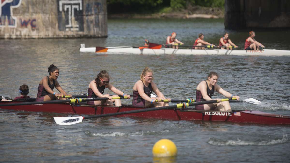 Exhausted contestants cross the finish line of the Dad Vail Regatta. (Branden Eastwood for WHYY)