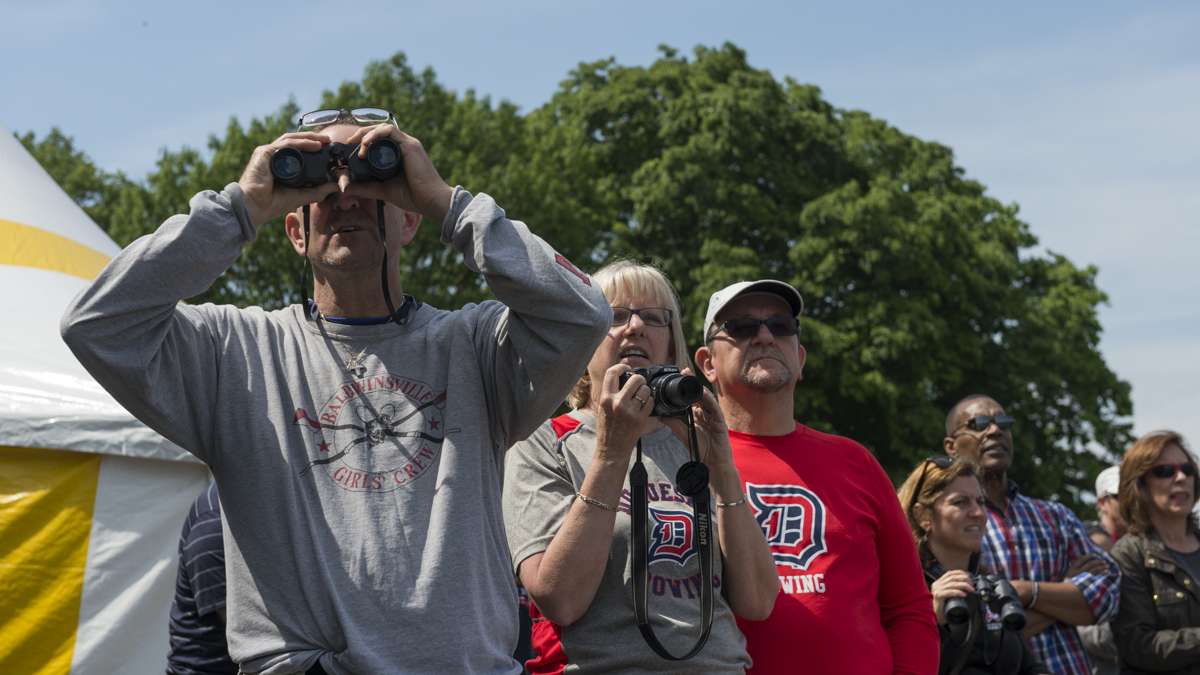 Eric Hughes takes in the action through his binoculars from a seat along the Schuylkill River.