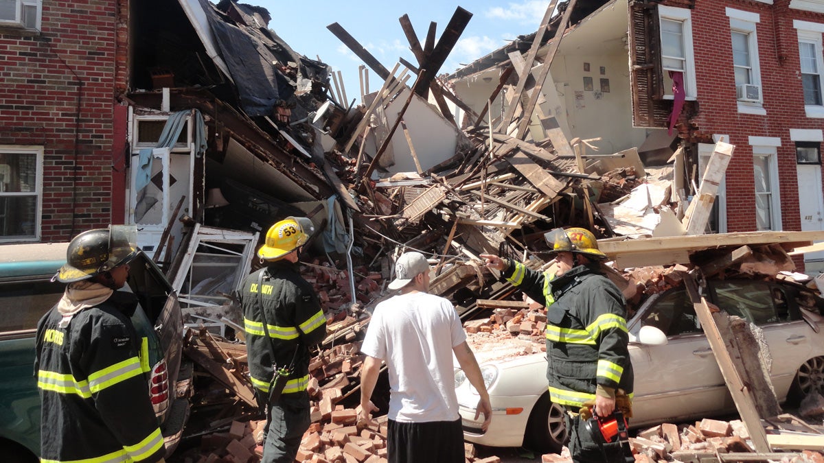  Joe Szymborski stands with firemen after having helped pull trapped residents out of one house damaged by the blast, according to Tom Smith. (Courtesy of Tom Smith) 