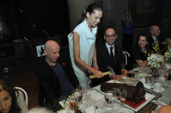 <p><p>Artist Philippe Parreno, the exhibition designer of "Dancing around the Bride" (left), and Philadelphia Museum of Art Contemporary Art curator Carlos Basualdo (right) watch as a Saks Fifth Avenue model breaks a chocolate bachelor dessert (Photo courtesy of Kelly & Massa Photography)</p></p>
