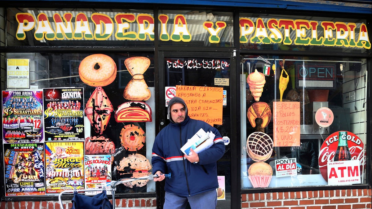 A mail carrier passes a closed bakery Thursday