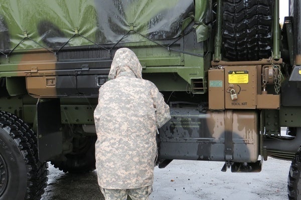 <p><p>A soldier with the 1049th Transportation Company refuels a vehicle that was taken to NYC. (Shana O'Malley/for NewsWorks)</p></p>
